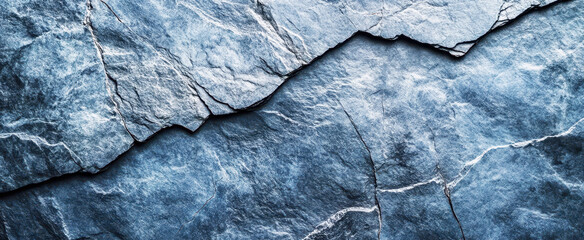 Dark blue gray stone texture background with a rough surface and cracks. Background of a natural rock wall texture for design or wallpaper