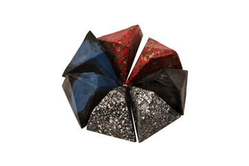 Chocolate candies in the form of precious stones, with marble texture, isolated on a white background.