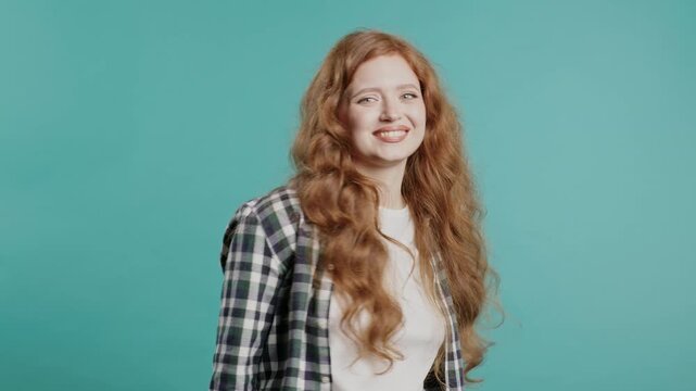 Beautiful woman in plaid shirt wear asks join her, beckons with inviting hand hugs gesture. Young lady calling - Hey you, come here. Playful, inviting to come