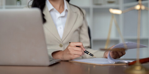 Professional Lawyer Working at Desk with Documents and Laptop in Modern Office Environment