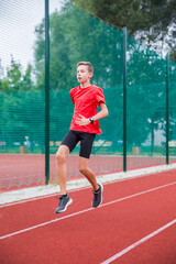 An athlete performs special running exercises at the stadium.