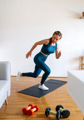 Caucasian young woman wearing sportswear doing fitness exercise at home. Active and healthy lifestyle.