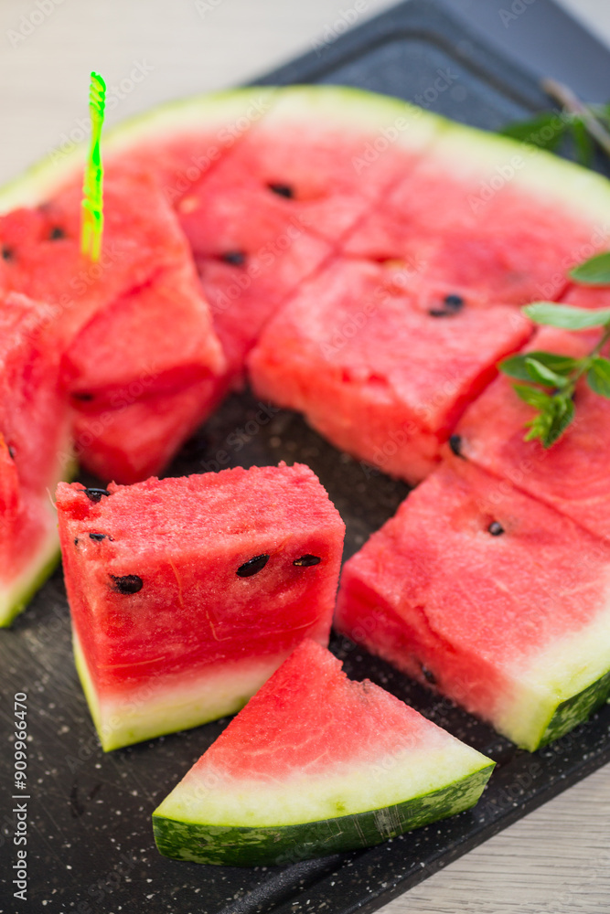 Poster pieces of ripe red watermelon, close-up, on a board