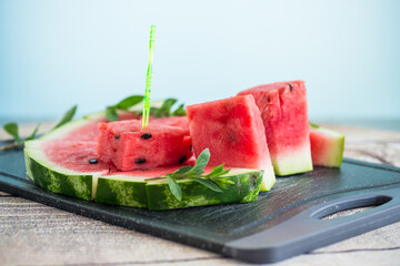 pieces of ripe red watermelon, close-up, on a board