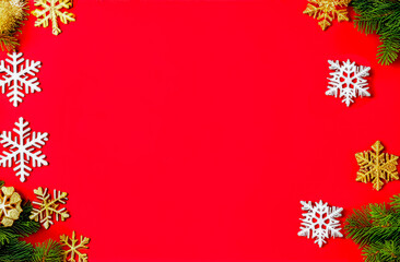 red Christmas background with snowflakes and fir branches with an empty text space in the center. a greeting card