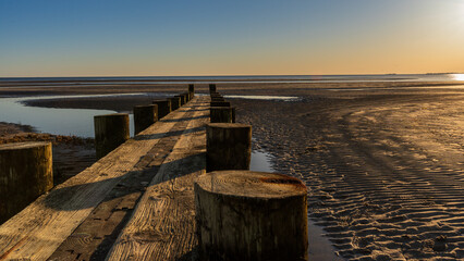 Breakwater at Harvey's Beach in Connecticut at sunset on a cloudless day