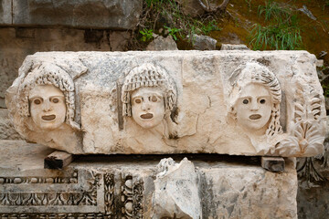 The Roman Theatre mask is carved in stone. The mask in ancient Greek theatre the relief on the...