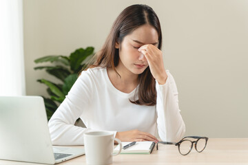 Eye problem concept, fatigue asian young woman tired eyes, irritated rubbing eye dry relief vision pain after work on laptop computer, eye strain, hand holding glasses, suffer migraine, bad blurry