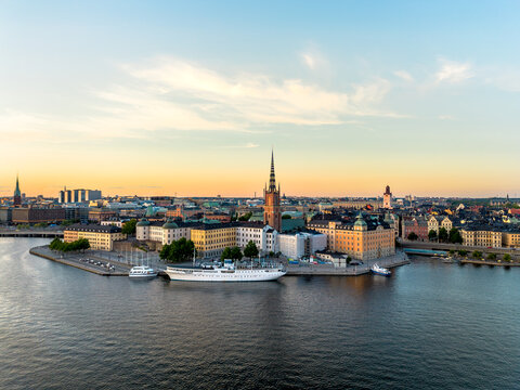 Aerial view of Gamla Stan, old town in Stockholm, Sweden in sunset with Riddarholmskyrkan church in foreground and a colorful clear sky background