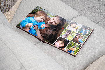 Open Family Photo Book on Sofa Top View.