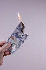 Cash is burning in gray background