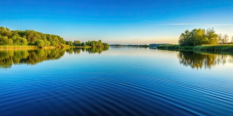 Obraz premium Gentle ripples on serene lake surface reflecting clear sky , peaceful, tranquil, water, nature, reflection, calm, serene