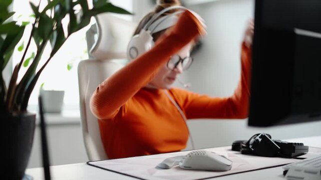 An Excited Gamer Joyfully Celebrating Their Victory in the Comfort of Their Own Home