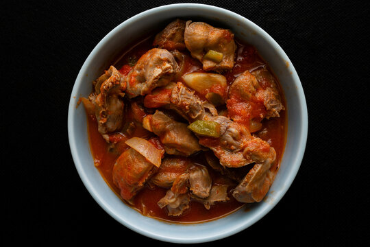 Portuguese dish "moelas" features tender chicken gizzards simmered in a rich tomato sauce, seasoned with garlic, onions, and traditional spices. Perfect for sharing with friends and family.