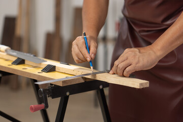 Senior man Cutting Dovetails With Woodworking Hand Tool for Hobby After retirement.