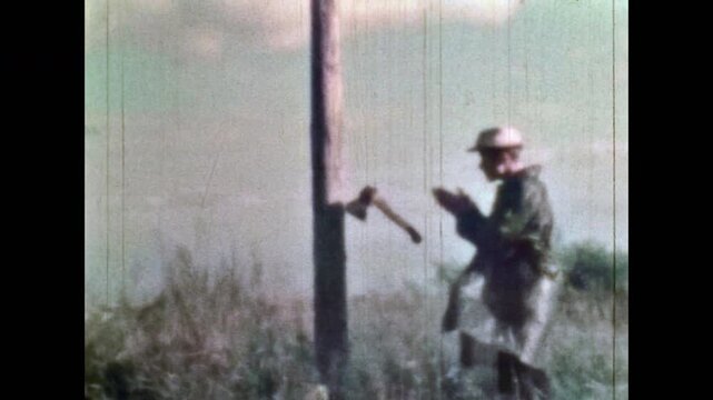 Repeat offender man sabotaging telegraph wires in countryside. Sabotage, wrecking of electrical equipment. Destroy accident. Man destroying electrical system outdoor. Vintage film. Retro 1960s archive