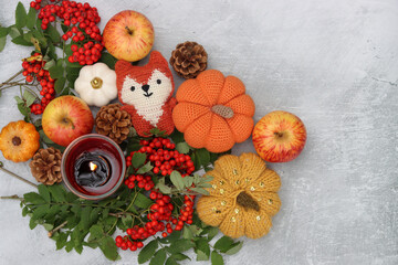 Warm Autumn still life. Colorful composition with decorative pumpkins, rowan berries, candle, leaves and flowers. Table decorations close up photo. Halloween celebration concept. 