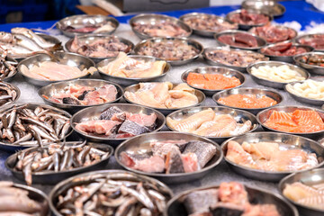 Different kind of seafod like cod, sprats, salmon, offerfed at the market in Rotterdam, Netherlands. Seafood, healthy, market trader, for cooking or frying, fish from the sea, market stall.