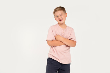 Portrait of smiling seven years old boy posing in studio