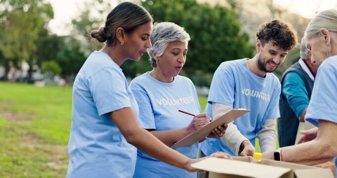 Charity, group or happy in park with donation, checklist or packing boxes for distribution. Teamwork, volunteering or people on grass for social responsibility, planning or NGO manager with clipboard
