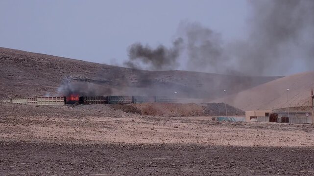 Residues burning violently at a recycling treatment plant. Medium Shot. Concept of environmental disaster due to the manufacture and handling of toxic substances.