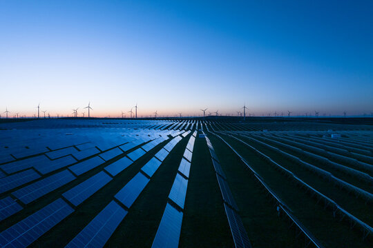 solar power station and wind power station at sunset