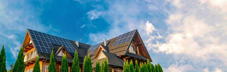 Fototapeta premium photovoltaic panels on a house against the blue sky