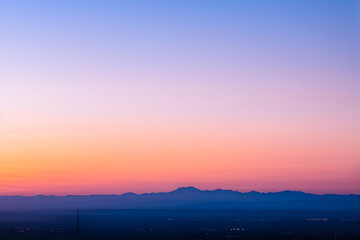 Serene dawn hues over tranquil mountains, this gradient backdrop captures the peaceful transition from night to day. The soft gradient from deep blue to pink creates a calming and picturesque scene