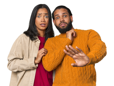 Young Latino couple in studio being shocked due to an imminent danger