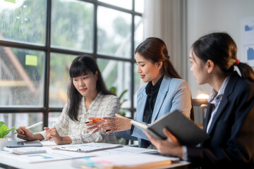 Asian businesswomen team working together on project having meeting in office