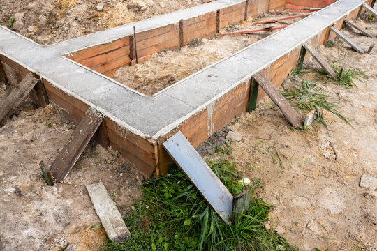 Freshly laid concrete, foundation in wooden formwork