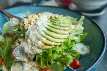 Salad avocado with Japanese style salad dressing, 
 vegetarian healthy eating, Vegan food.