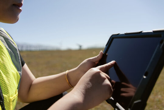 female technician working with tablet in solar power station