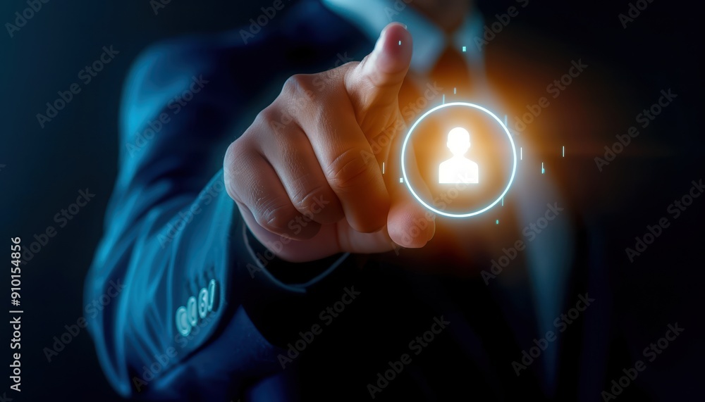 Poster close-up of a businessman pointing at a user icon hologram in a dark environment, representing techn