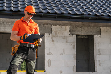 Construction Worker Assessing Building Progress on a New Site During Daylight Hours