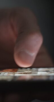 Close up of fingers typing and scrolling on mobile application
