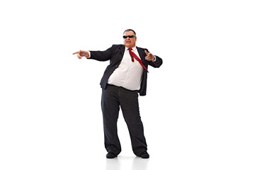 Fototapeta premium Positive vibe and confidence. Fat man, businessman in sunglasses and formal wear dancing, showing good emotions isolated on white background. Concept of business, leisure, achievement