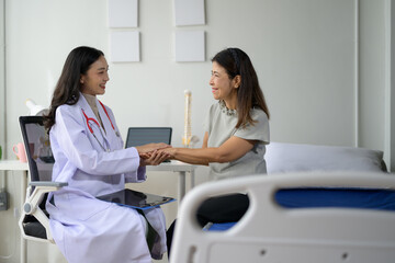 Fototapeta premium Female Doctor Comforting Patient in Modern Medical Office During Consultation