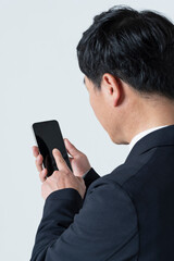 スマートフォンを使う50代男性の手元
