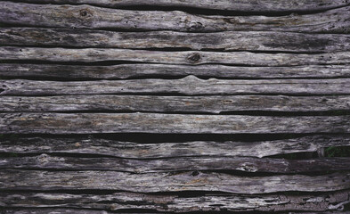 Fototapeta premium Dark brown wood natural wooden bridge, abstract tree trunk background and texture. patterns, quoit, old, ancient, rotted,obsolete weathered, space for work, vintage wallpaper, close up