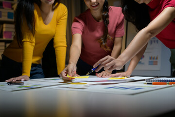 Fototapeta premium Team of Young Professionals Collaborating on Project in Modern Office Environment