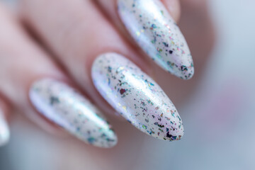 beautiful female hands with long nails light white and green manicure