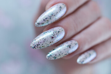 beautiful female hands with long nails light white and green manicure