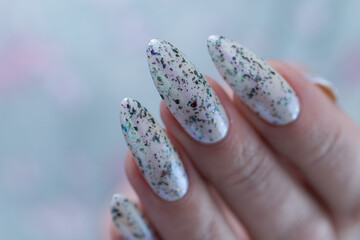 beautiful female hands with long nails light white and green manicure