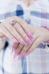 Woman's hands with long nails and light pink manicure 