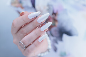 beautiful female hands with long nails light white manicure