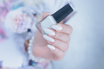 beautiful female hands with long nails light white manicure