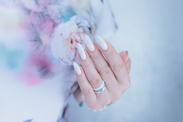 beautiful female hands with long nails light white manicure