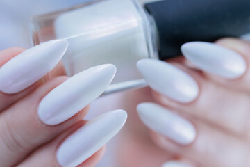 beautiful female hands with long nails light white manicure