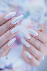 beautiful female hands with long nails light white manicure